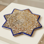 Unique Persian lustreware star tile inspired by Ilkhanid ceramic art and decorated with a traditional golden medallion design.