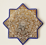 Handcrafted Persian lustreware star tile in Ilkhanid style featuring a golden medallion motif, created in Winter 2025 by the Tavasolian Brothers Workshop