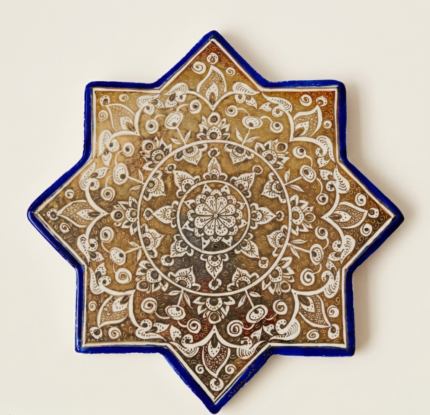Handcrafted Persian lustreware star tile in Ilkhanid style featuring a golden medallion motif, created in Winter 2025 by the Tavasolian Brothers Workshop